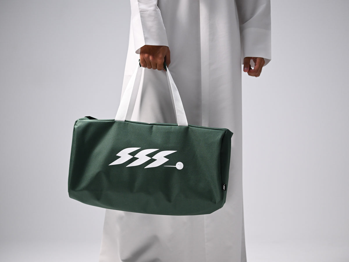 A dark green duffel bag with white handles and a white stylized SSS.