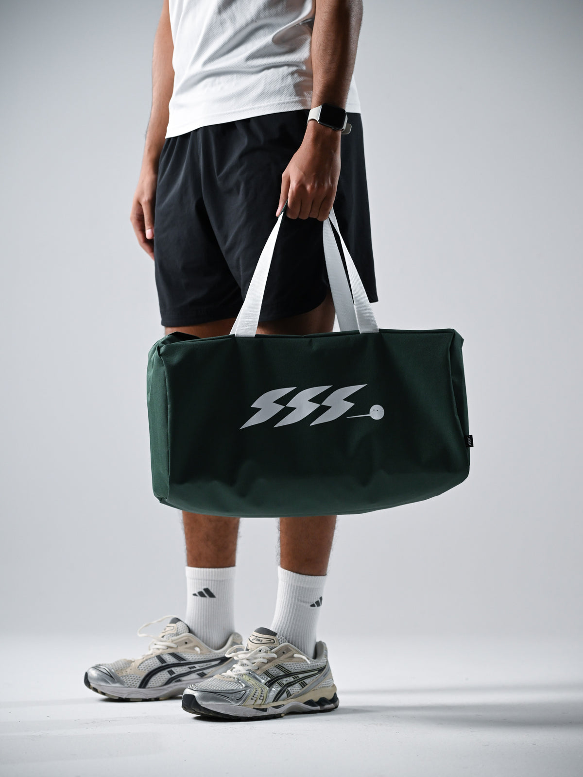 A dark green duffel bag with white handles and a white stylized 'SSS' logo.